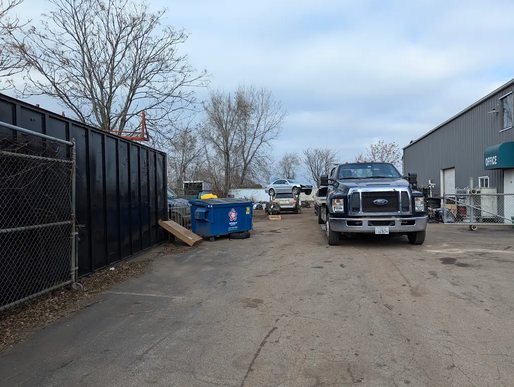 The A-Affordable Auto Parts yard in Joliet with a tow truck beside the office building